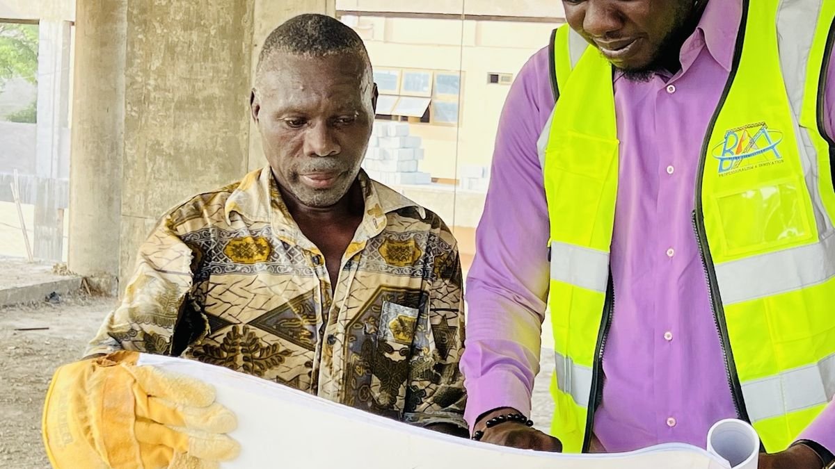 Deux professionnels consultant des plans de construction sur un chantier